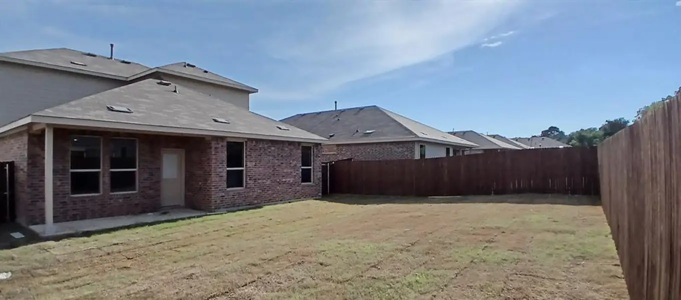 Front exterior of a new home in The Canyons, Keene, TX, highlighting curb appeal (Image 2).