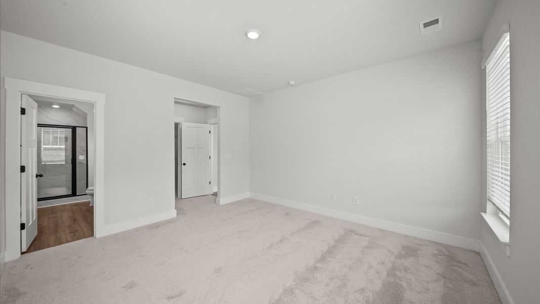 Spacious and serene primary suite with thoughtful design in a desirable DRB Homes community