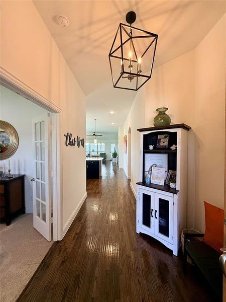 Entryway featuring wood-finish flooring extending through the hall Entryway featuring wood-finish flooring extending through the hall
