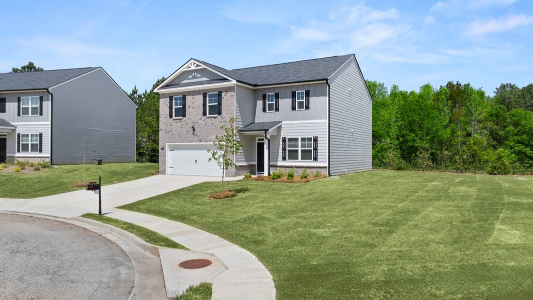 Front exterior of a new home in Locust Grove Station - Cedar Ridge, Locust Grove, GA, highlighting curb appeal (Image 17). Front exterior of a new home in Locust Grove Station - Cedar Ridge, Locust Grove, GA, highlighting curb appeal (Image 17).
