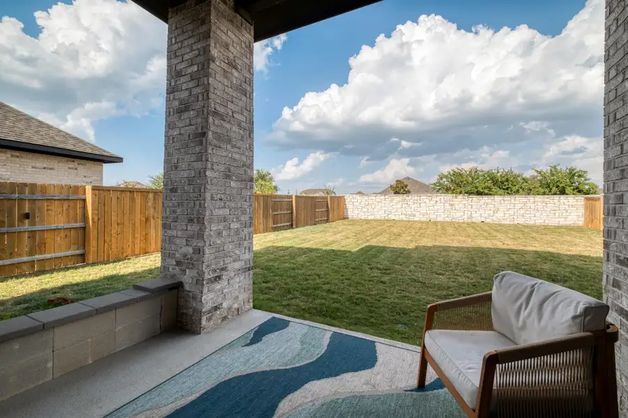 A covered patio creates a shaded spot to relax while keeping the entire yard in view.