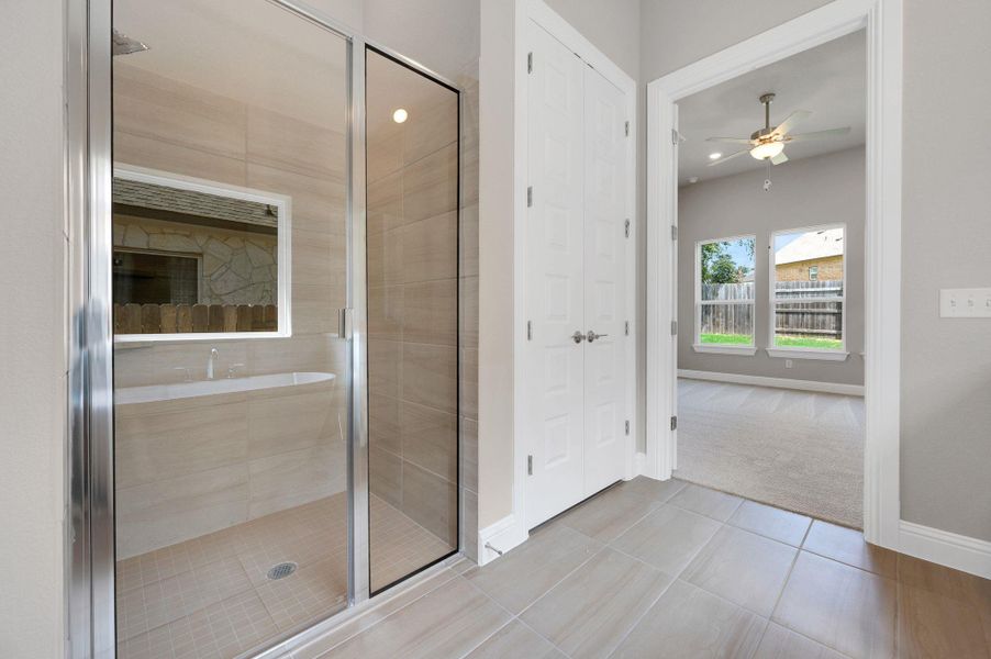 Full bathroom with a ceiling fan, tile patterned flooring, a stall shower, recessed lighting, and a closet
