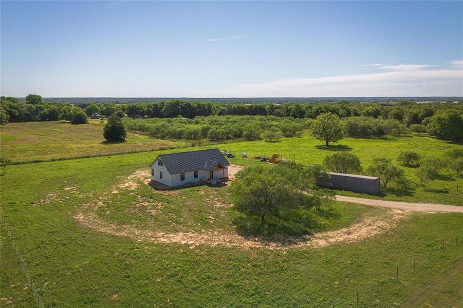 Aerial view of sparsely populated area featuring a pastoral area