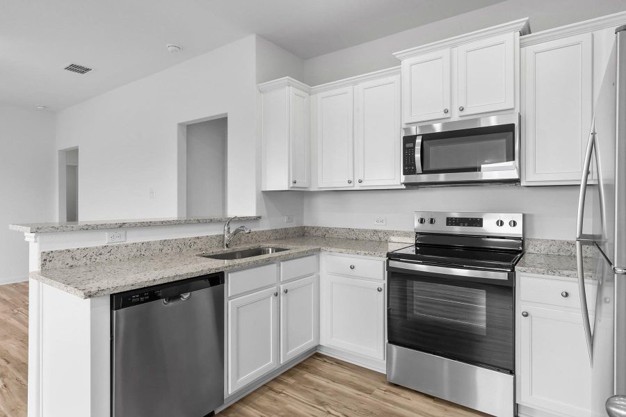 Chef-ready kitchen with Stainless steel kitchen appliances and granite countertops