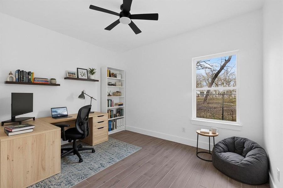 Office area with wood tiled floors and ceiling fan