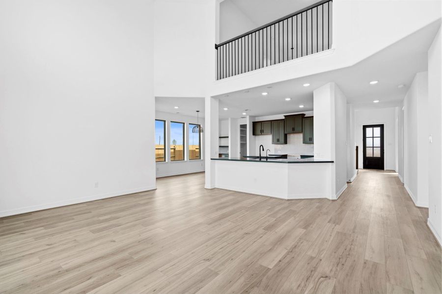 Spacious two-story family room with open flow to the kitchen, perfect for family gatherings and lifestyle living.