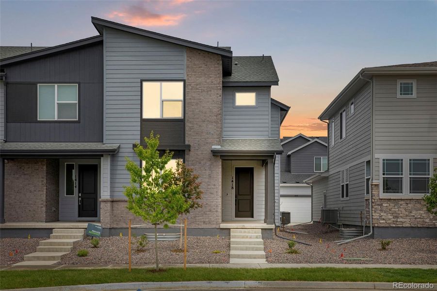 Front exterior of a new home in Sugar Mill Village, Longmont, CO, highlighting curb appeal (Image 21). Front exterior of a new home in Sugar Mill Village, Longmont, CO, highlighting curb appeal (Image 21).