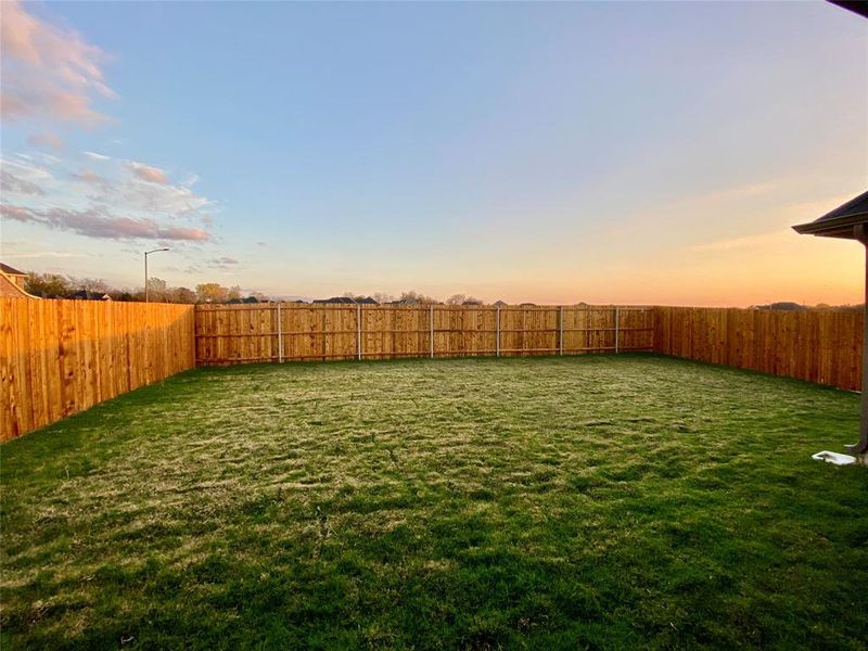 Great, flat, back yard with stained fence & metal posts is a blank slate waiting for your special touches! Great, flat, back yard with stained fence & metal posts is a blank slate waiting for your special touches!