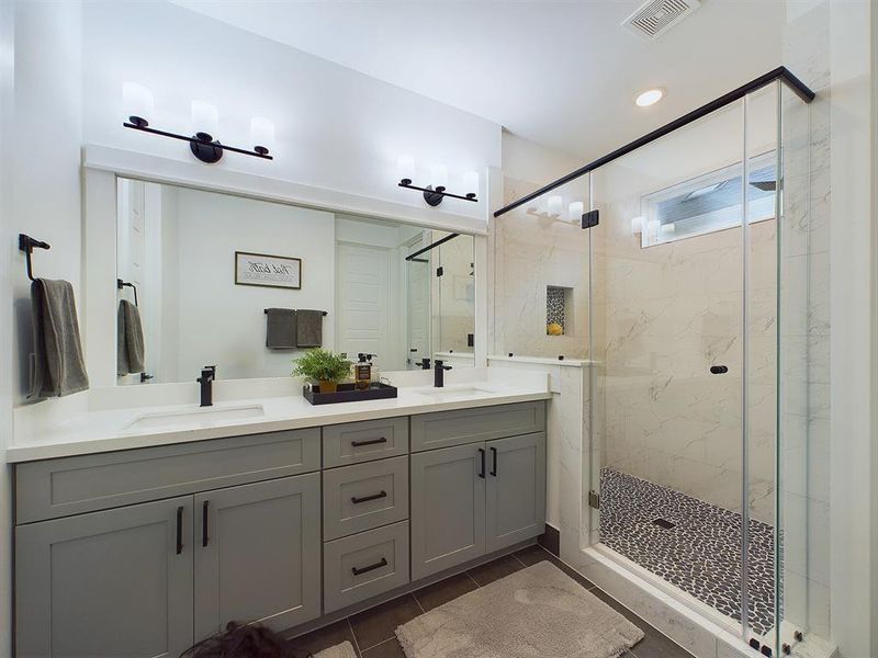 Primary Bathroom features a gorgeous semi-frameless glass shower door.