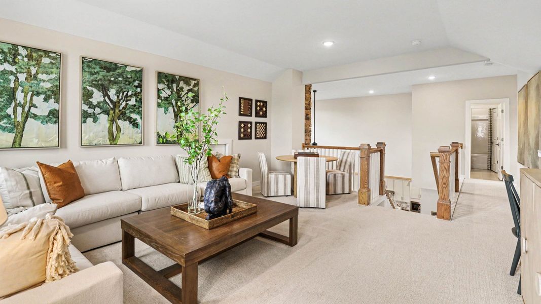 Spacious loft area with carpet and access to bedrooms