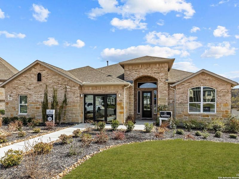 Front exterior of a new home in The Reserve at Potranco Oaks, Castroville, TX, highlighting curb appeal (Image 2).