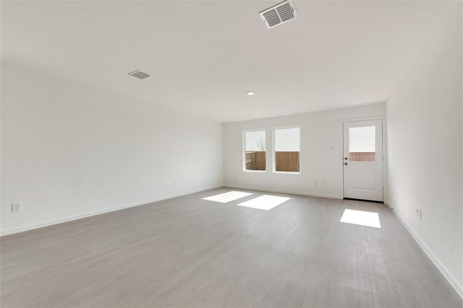 Spare room with light wood-style floors and recessed lighting