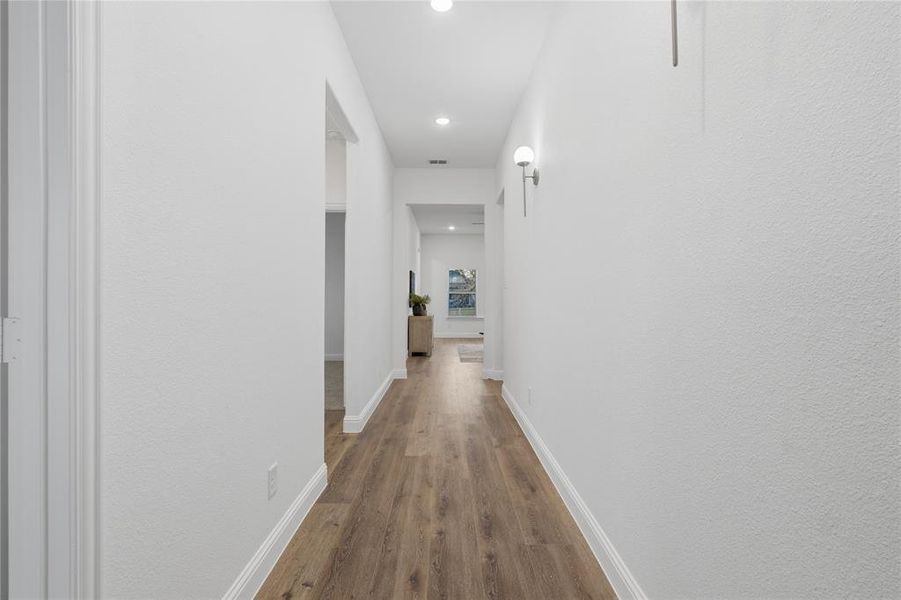 Hall featuring recessed lighting and dark wood finished floors