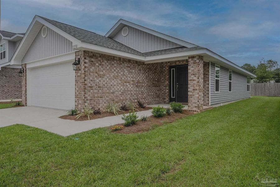 Front exterior of a new home in Allison Acres, Cantonment, FL, highlighting curb appeal (Image 2).