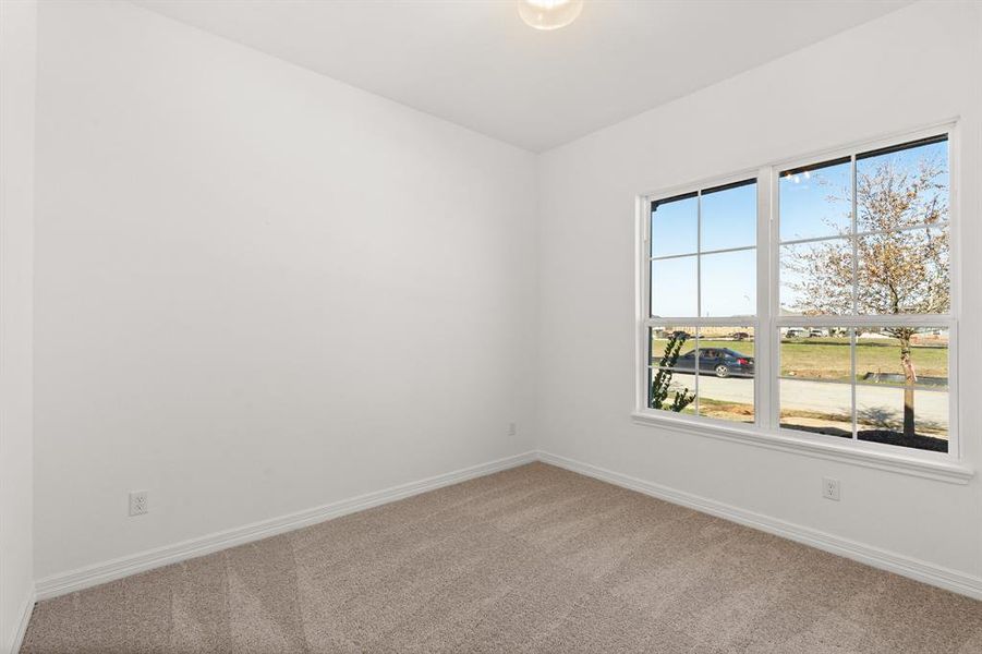 Your secondary bedroom features plush carpet, fresh paint, closet, and a large window that lets in plenty of natural lighting.