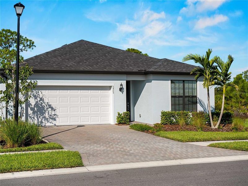 Front exterior of a new home in , North Port, FL, highlighting curb appeal (Image 22). Front exterior of a new home in , North Port, FL, highlighting curb appeal (Image 22).