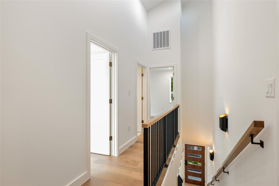 Clean lines and a modern railing guide the eye down this sun-drenched stairwell. Clean lines and a modern railing guide the eye down this sun-drenched stairwell.