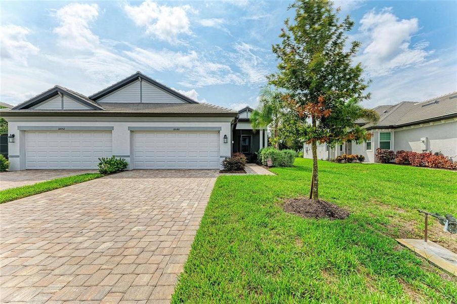 Front exterior of a new home in , Lakewood Ranch, FL, highlighting curb appeal (Image 22).
