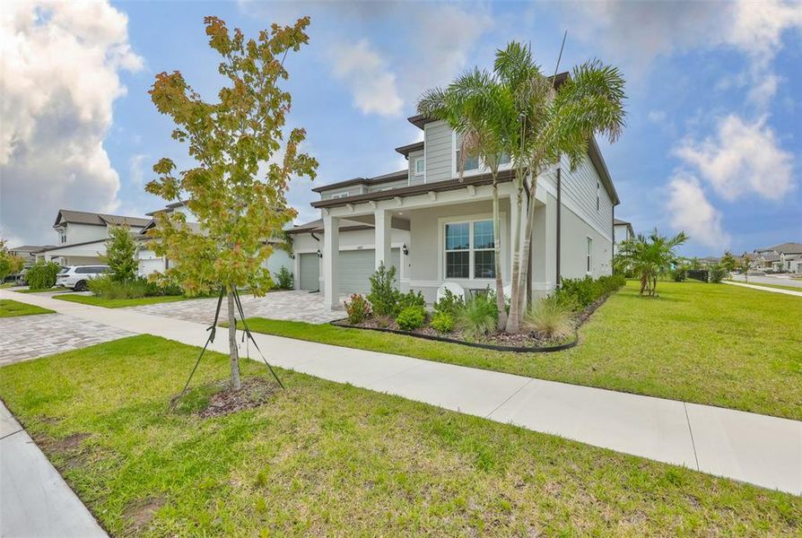 Front exterior of a new home in , Apollo Beach, FL, highlighting curb appeal (Image 26).