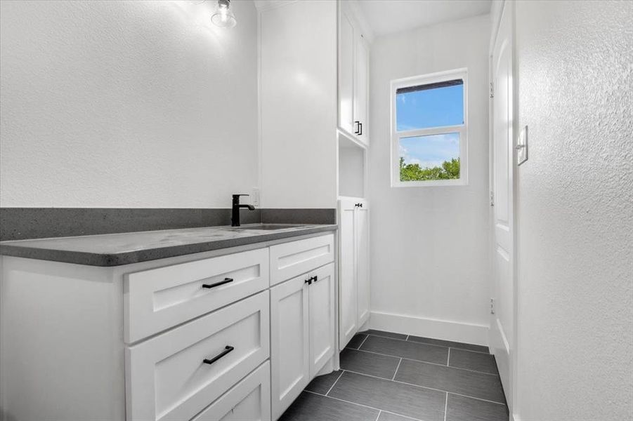 Bathroom with sink and tile floors