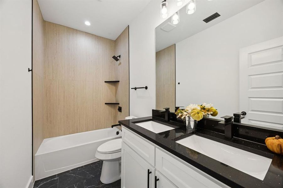 Full bathroom featuring tub / shower combination, vanity, dark marble finish flooring, and recessed lighting