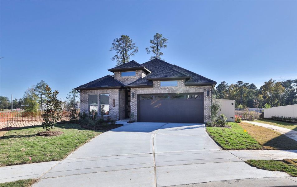 Front exterior of a new home in Audubon Park 45', Magnolia, TX, highlighting curb appeal (Image 7).