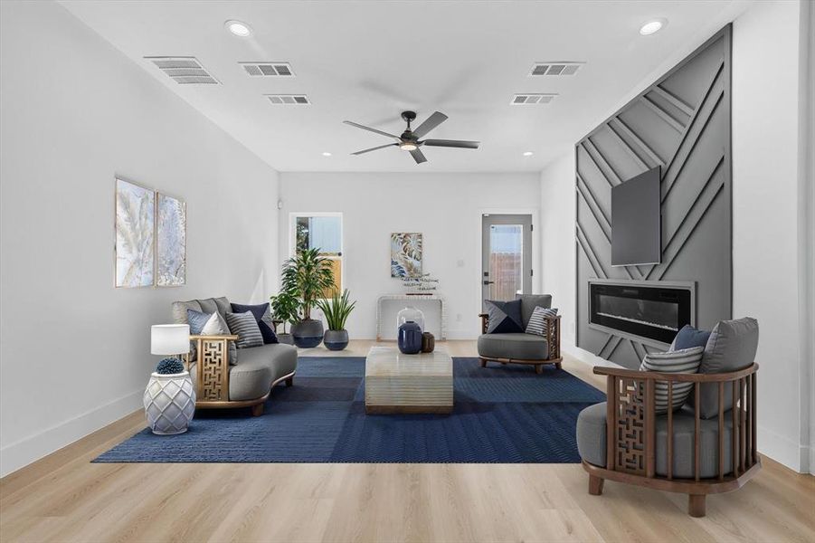 Living room featuring light wood finished floors, plenty of natural light, ceiling fan, and recessed lighting