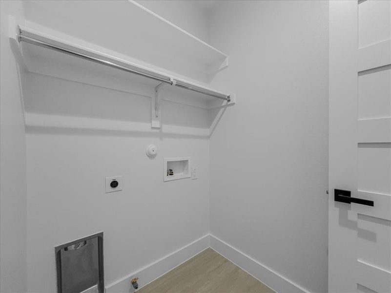 Laundry area with hookup for a gas dryer, light wood-style flooring, washer hookup, and electric dryer hookup Laundry area with hookup for a gas dryer, light wood-style flooring, washer hookup, and electric dryer hookup