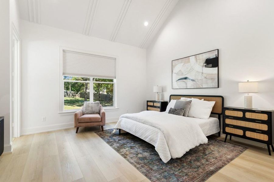 Bedroom featuring light wood-style flooring, recessed lighting, and high vaulted ceiling
