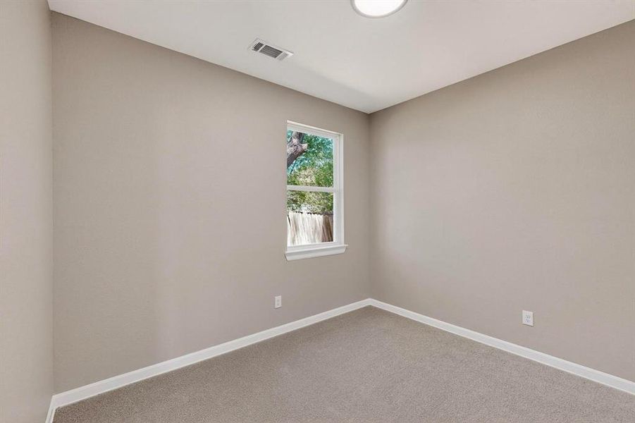 Carpeted spare room with baseboards Carpeted spare room with baseboards