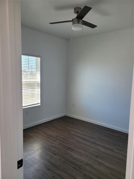Laminate flooring and a window with blinds define this versatile room.