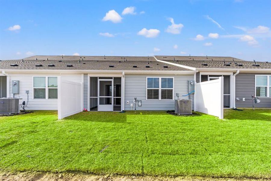 Exterior details and patio area of a home in Lakes at Riverbend Townhomes, Navassa (Image 2).