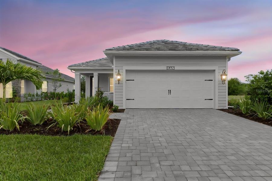 Front exterior of a new home in Verandah, Fort Myers, FL, highlighting curb appeal (Image 1). Front exterior of a new home in Verandah, Fort Myers, FL, highlighting curb appeal (Image 1).