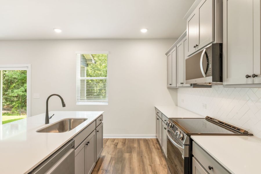 A kitchen with white cabinets. A kitchen with white cabinets.