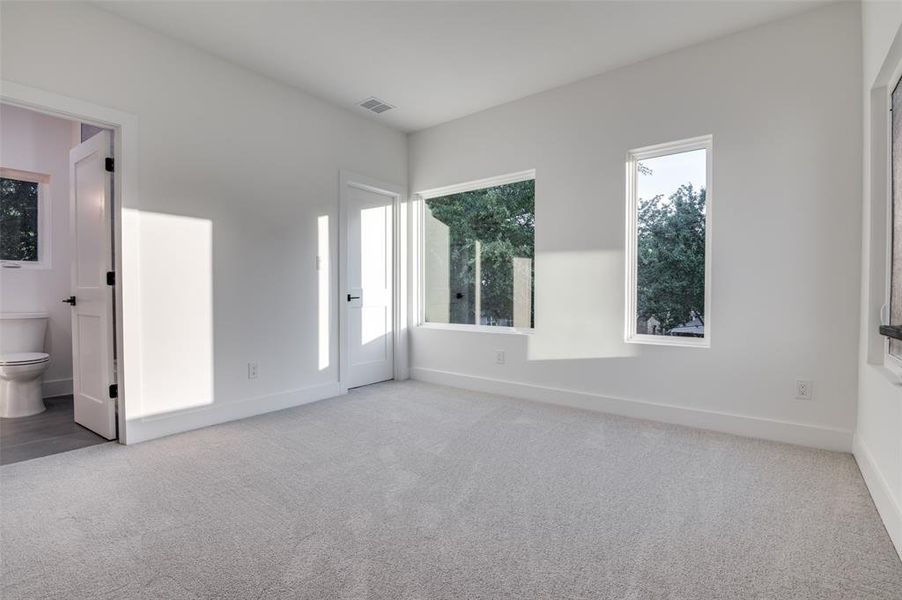 Unfurnished bedroom featuring carpet floors and connected bathroom