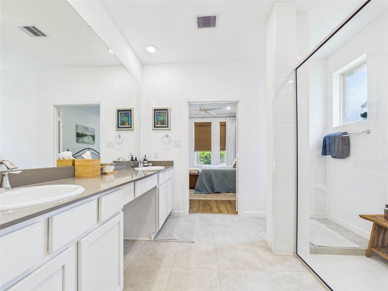 The en-suite primary bathroom offers double sinks and vanity area, massive walk-in shower, private toilet room, and linen closet.