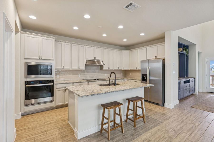 Kitchen with built-in microwave and oven