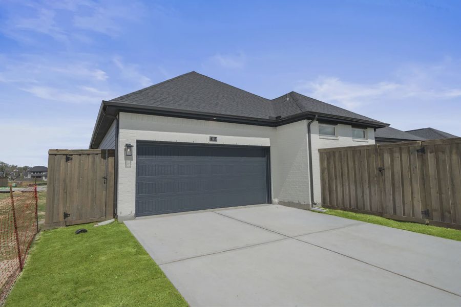 Representative exterior photo of a completed home built from the Augusta by Chesmar Homes in Riceland Alley Loads, Mont Belvieu, TX (Image 19).