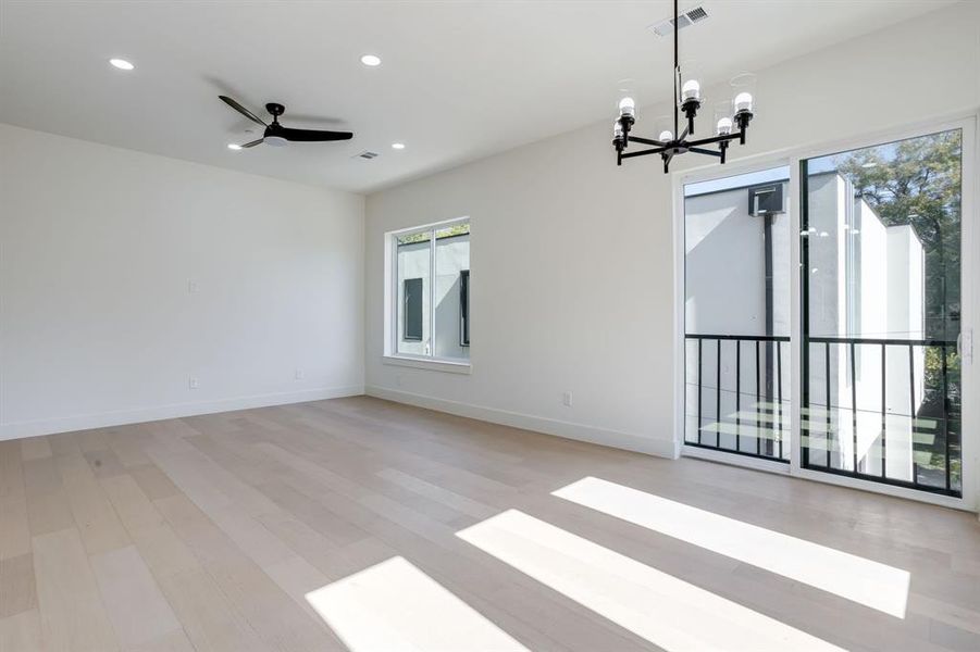 Unfurnished room featuring recessed lighting, light wood-style flooring, a chandelier, and ceiling fan