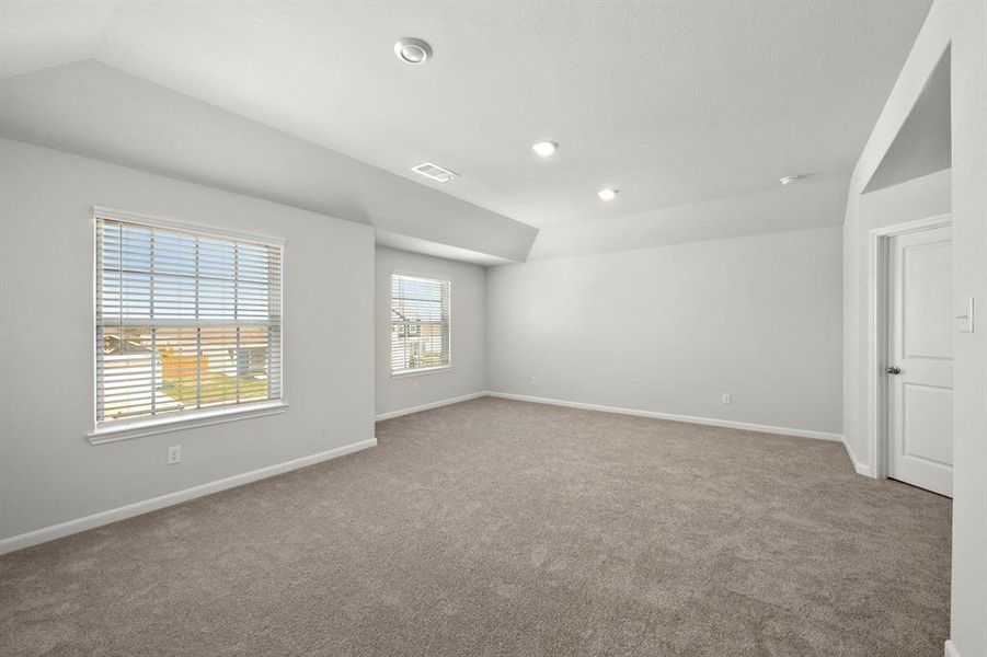 The expansive, primary bedroom is the perfect place to relax after a long day.