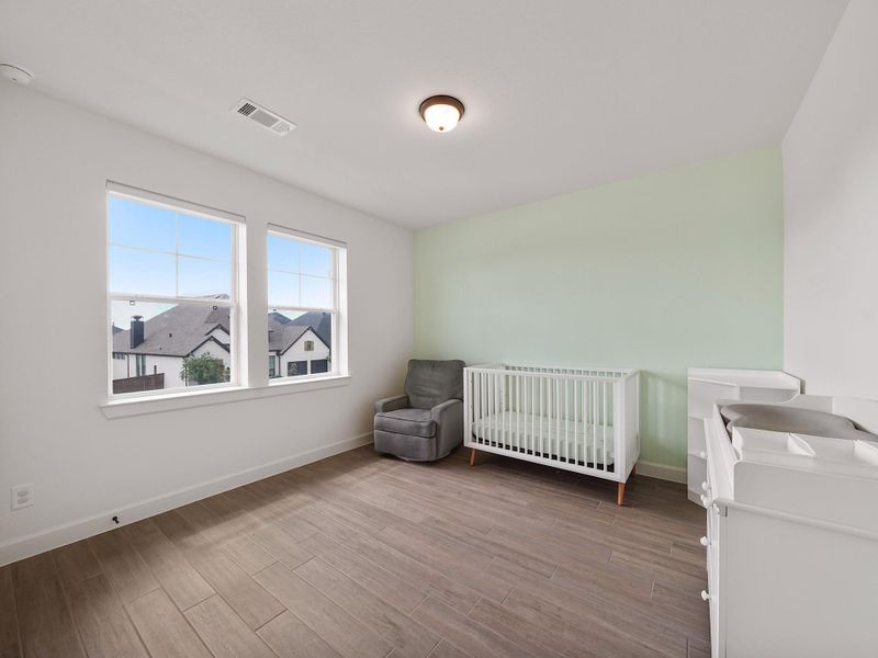 Another upstairs bedroom provides flexibility for family, guests, or even a hobby or craft space.