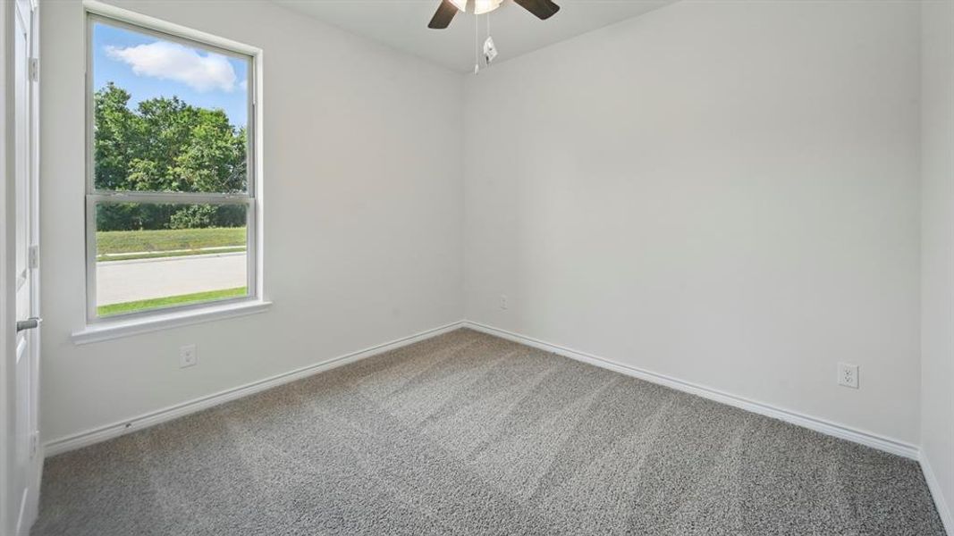 Spare room with carpet flooring and a ceiling fan