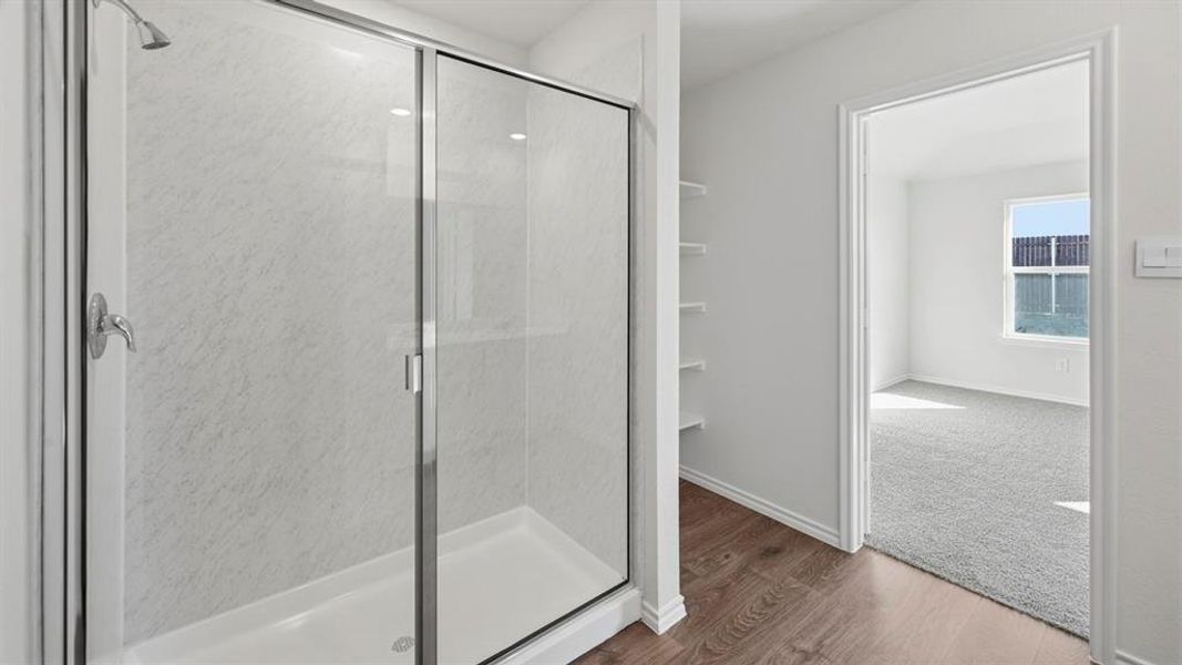 Full bathroom with a shower stall and dark wood-type flooring Full bathroom with a shower stall and dark wood-type flooring