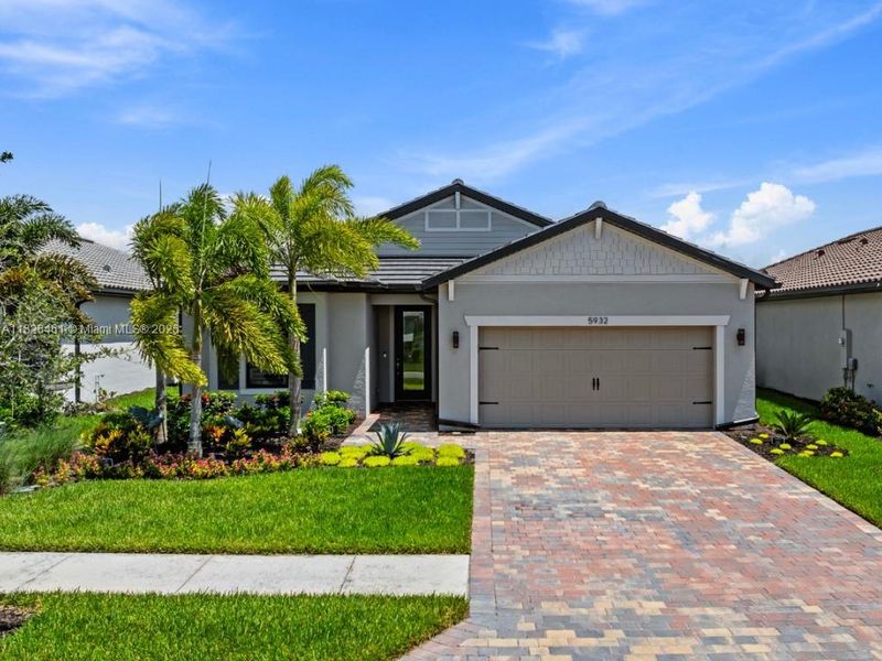 Front exterior of a new home in Del Webb Naples, Ave Maria, FL, highlighting curb appeal (Image 2).