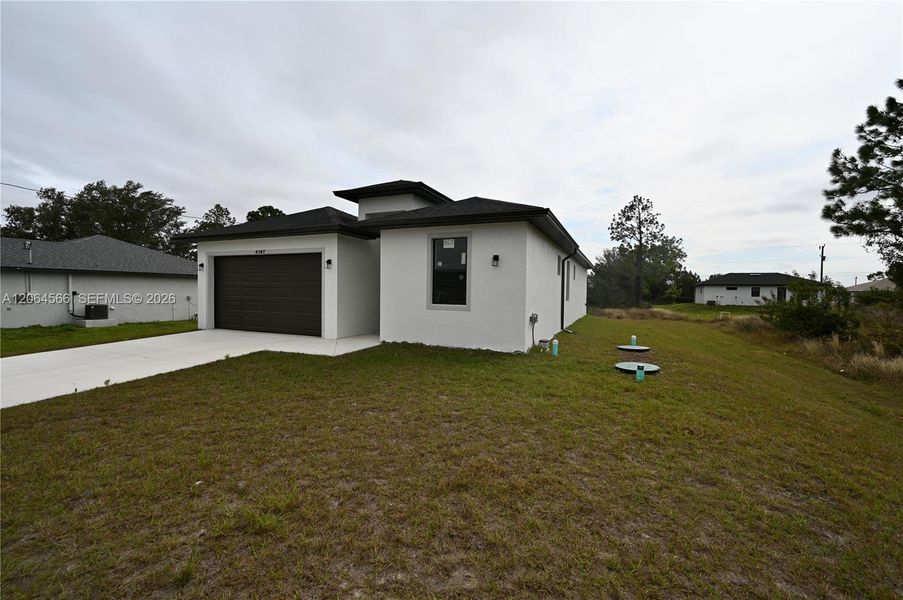 Front exterior of a new home in , Lehigh Acres, FL, highlighting curb appeal (Image 2). Front exterior of a new home in , Lehigh Acres, FL, highlighting curb appeal (Image 2).