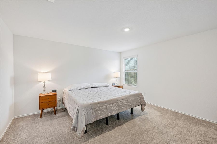 Plush carpeted flooring complements light-toned walls Plush carpeted flooring complements light-toned walls