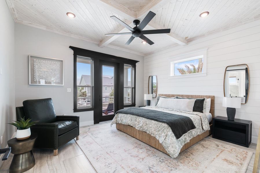 Bedroom with a wood ceiling with exposed beams, multiple windows, wooden walls, recessed lighting, and wood finished floors Bedroom with a wood ceiling with exposed beams, multiple windows, wooden walls, recessed lighting, and wood finished floors