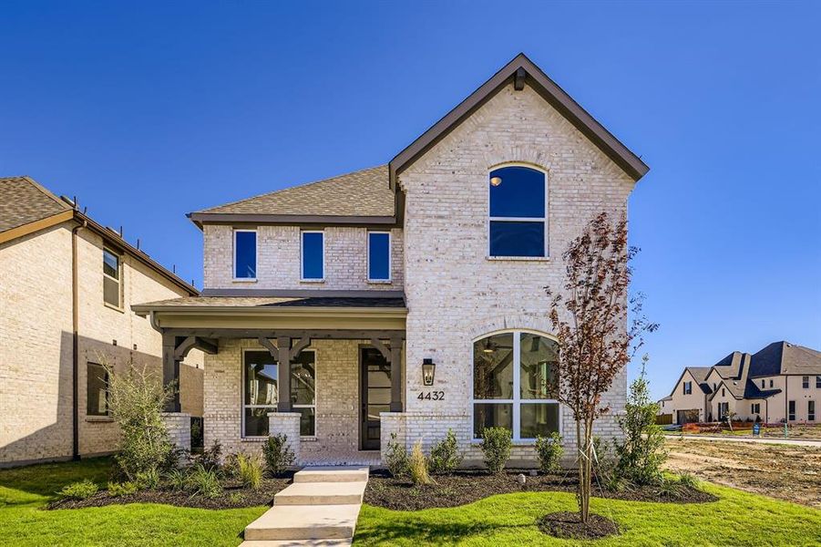 View of front facade with a porch, brick siding, a front lawn, and a shingled roof View of front facade with a porch, brick siding, a front lawn, and a shingled roof