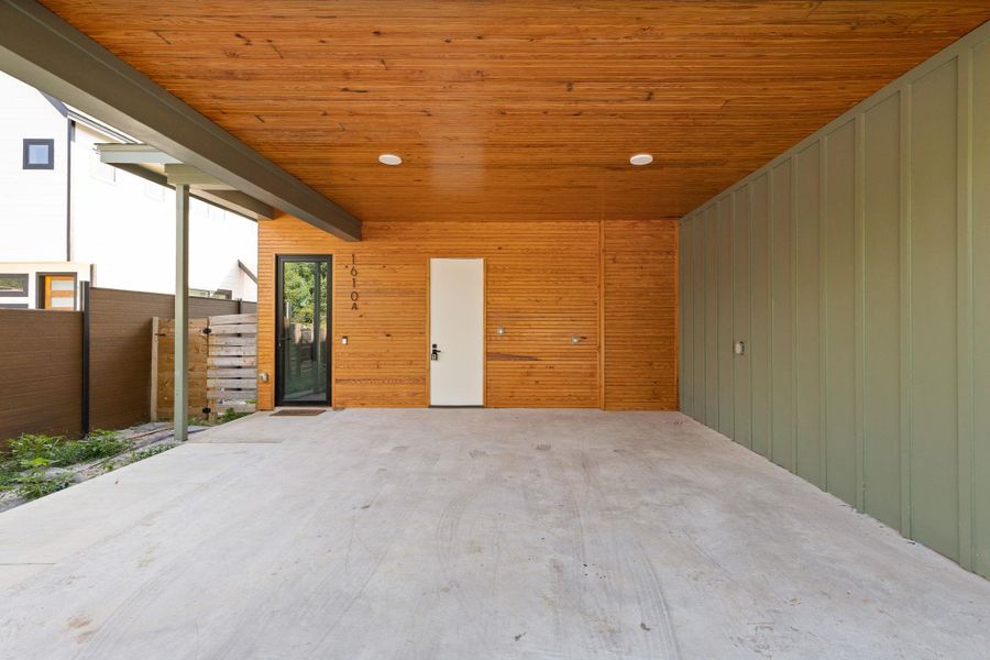 A well-designed carport offers sheltered parking with modern wood and metal accents.
