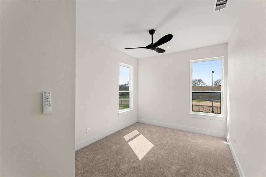 Spare room with carpet floors and a ceiling fan